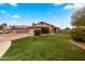 Front lawn featuring lush grass, desert landscaping, and a welcoming two-car garage at 1993 S Spartan St, Gilbert, AZ 85233