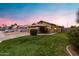 Inviting home exterior with a well-manicured lawn, mature shrubbery and desert landscaping at 1993 S Spartan St, Gilbert, AZ 85233