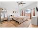 Cozy main bedroom featuring a ceiling fan, bay window, and warm decor at 1993 S Spartan St, Gilbert, AZ 85233