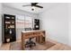 Bright office space featuring a wooden desk, shelves, and natural light from the window at 1993 S Spartan St, Gilbert, AZ 85233