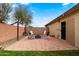 Cozy brick patio with seating and string lights, creating a welcoming outdoor space for relaxation and gatherings at 1993 S Spartan St, Gilbert, AZ 85233