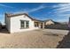 This backyard features low-maintenance gravel, a custom paved patio, and lush artificial turf at 20183 W Monroe St, Buckeye, AZ 85326