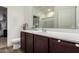 A clean bathroom with dark wood cabinets and vinyl floors at 20183 W Monroe St, Buckeye, AZ 85326