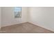 An empty bedroom with carpet flooring and natural lighting at 20183 W Monroe St, Buckeye, AZ 85326