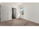 Bedroom featuring a window allowing plenty of light, neutral carpet and fresh white walls at 20183 W Monroe St, Buckeye, AZ 85326