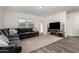 Bright living room featuring a sectional sofa, tv stand, and ample natural light at 20183 W Monroe St, Buckeye, AZ 85326