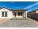 A backyard showing a custom paved patio, framed by gravel and artificial turf for outdoor living at 20183 W Monroe St, Buckeye, AZ 85326