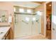 Bright bathroom with a walk-in shower, grab bars, and access to a spacious closet at 20742 E Mockingbird Dr, Queen Creek, AZ 85142