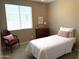 Bright bedroom featuring a comfortable bed, chest of drawers, and chair near a window at 20742 E Mockingbird Dr, Queen Creek, AZ 85142