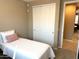Well-lit bedroom with a comfortable bed and sliding door closet at 20742 E Mockingbird Dr, Queen Creek, AZ 85142
