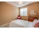 Cozy bedroom features neutral walls, ceiling fan, and natural light from the window at 20742 E Mockingbird Dr, Queen Creek, AZ 85142