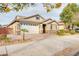 Inviting home showcasing a wide driveway, lush landscaping, and a welcoming facade at 20742 E Mockingbird Dr, Queen Creek, AZ 85142