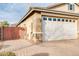 Garage and side yard showcasing the brick-paved driveway, and gate entrance at 20742 E Mockingbird Dr, Queen Creek, AZ 85142