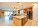 Open-concept kitchen featuring a center island, dark cabinets, and seamless flow into the dining and living areas at 20742 E Mockingbird Dr, Queen Creek, AZ 85142