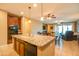 Well-lit kitchen with a large island, dark cabinetry, and stainless appliances creating a functional and stylish space at 20742 E Mockingbird Dr, Queen Creek, AZ 85142