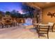 Inviting back patio with a fireplace, hot tub, and comfortable seating at dusk at 20750 N 87Th St # 1137, Scottsdale, AZ 85255