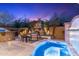 Stunning outdoor space featuring a spa, fireplace, and outdoor kitchen perfect for entertaining guests in the evening at 20750 N 87Th St # 1137, Scottsdale, AZ 85255