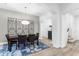 Elegant dining room featuring a modern light fixture and a stylish blue patterned rug at 20750 N 87Th St # 1137, Scottsdale, AZ 85255