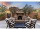 Relaxing outdoor space with desert landscaping around a cozy fireplace at 20750 N 87Th St # 1137, Scottsdale, AZ 85255