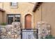 Charming front entrance with stone accents, a gated courtyard, and an arched doorway at 20750 N 87Th St # 1137, Scottsdale, AZ 85255