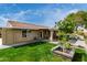 Well-manicured lawn, patio area, brick house with red tile roof, mature landscaping, and a vibrant atmosphere at 212 W Interlacken Dr, Phoenix, AZ 85023