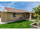 Backyard featuring well-maintained lawn, brick exterior, and manicured landscaping at 212 W Interlacken Dr, Phoenix, AZ 85023