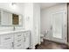 Clean bathroom showcasing modern fixtures, a vanity with ample storage, and a decorative mirror at 212 W Interlacken Dr, Phoenix, AZ 85023