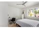 Bright bedroom with large window, sleek desk, and stylish mirror for added functionality at 212 W Interlacken Dr, Phoenix, AZ 85023