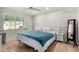 Bright bedroom featuring a queen-size bed, neutral walls, tile floors, and a sunlit window at 212 W Interlacken Dr, Phoenix, AZ 85023