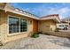 Inviting front entrance featuring a modern wood door, brick accents, and colorful flowers at 212 W Interlacken Dr, Phoenix, AZ 85023