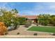 Charming single-story home with mature landscaping, a red tile roof, and well-manicured front yard at 212 W Interlacken Dr, Phoenix, AZ 85023