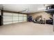 Spacious garage with brick walls featuring epoxy floors and ample space for vehicles and storage solutions at 212 W Interlacken Dr, Phoenix, AZ 85023