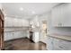 Bright kitchen featuring white cabinets, subway tile backsplash, modern appliances, and a door to the outside at 212 W Interlacken Dr, Phoenix, AZ 85023