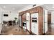 Modern kitchen area with a brick archway, stainless steel appliances, and a connected dining space at 212 W Interlacken Dr, Phoenix, AZ 85023