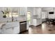 Modern kitchen with white cabinets, subway tile, stainless steel appliances, a farmhouse sink, and an adjacent dining area at 212 W Interlacken Dr, Phoenix, AZ 85023