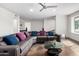 Spacious living room featuring a modern ceiling fan, comfortable seating, and natural light at 212 W Interlacken Dr, Phoenix, AZ 85023