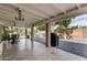 Covered patio with ceiling fans, barbecue, and a dining area for outdoor gatherings at 212 W Interlacken Dr, Phoenix, AZ 85023