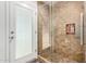 Tiled standup shower with glass door and an in-wall niche for toiletries at 212 W Interlacken Dr, Phoenix, AZ 85023