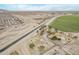 Expansive aerial view of the property with a nearby canal, nestled between residential and farmland at 21520 W Watkins St, Buckeye, AZ 85326