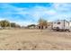 Expansive backyard featuring a trailer, partial fencing, and a view of the home at 21520 W Watkins St, Buckeye, AZ 85326