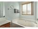 Bathroom with soaking tub and window at 21520 W Watkins St, Buckeye, AZ 85326