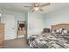 Bright bedroom featuring a bed with a patterned quilt, closet and a wooden ladder shelf with blankets at 21520 W Watkins St, Buckeye, AZ 85326