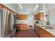 A bright kitchen with stainless steel appliances, wood cabinets and wood tile floors at 21520 W Watkins St, Buckeye, AZ 85326