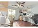 Bright home office featuring light blue walls, wood floors, large window and built-in shelving and desk at 21520 W Watkins St, Buckeye, AZ 85326