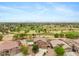 Expansive aerial view of desert home with golf course frontage, offering scenic views and community living at 21798 N Ingram Ct, Maricopa, AZ 85138