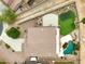 Overhead shot of luxury home featuring a pool, putting green, basketball court, and desert landscaping at 21798 N Ingram Ct, Maricopa, AZ 85138