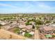 Overhead view of desert community with pools, putting greens, lush landscaping, and sunny weather at 21798 N Ingram Ct, Maricopa, AZ 85138