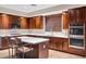 A kitchen featuring stainless steel appliances, a large island, and rich wood cabinetry at 21798 N Ingram Ct, Maricopa, AZ 85138