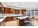 Gourmet kitchen featuring stainless steel appliances, a large island, and rich wood cabinetry at 21798 N Ingram Ct, Maricopa, AZ 85138