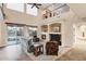 Open-concept living room featuring a fireplace, high ceilings, and natural light from sliding doors to the backyard at 21798 N Ingram Ct, Maricopa, AZ 85138